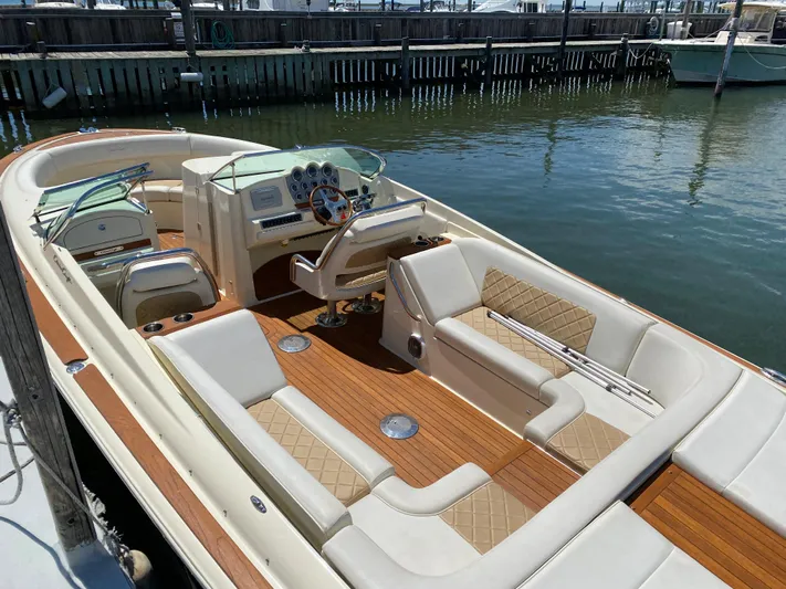  Yacht Photos Pics 2014 Chris-Craft Launch 28 boat with elegant interior and wooden deck, docked at marina.