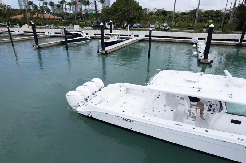 Our Trade Yacht Photos Pics 2024 HCB 53 Sueños boat docked in a marina with multiple engines.