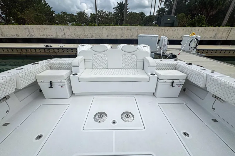 Our Trade Yacht Photos Pics 2024 HCB 53 Sueños boat interior with white seating and coolers at dock.