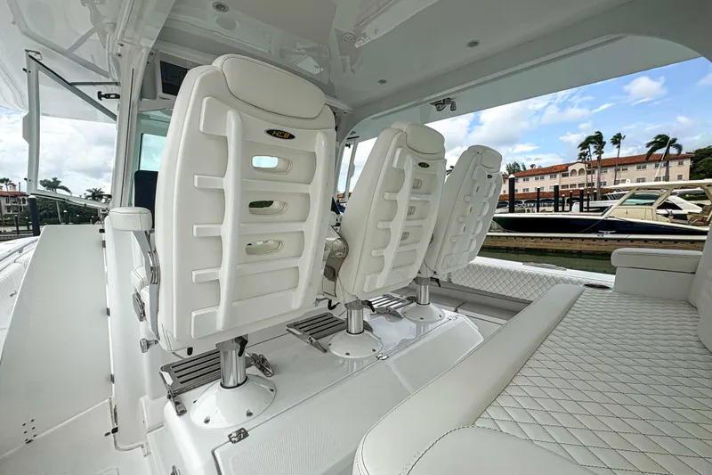 Our Trade Yacht Photos Pics 2024 HCB 53 Sueños boat interior with luxurious white seating and marina view.