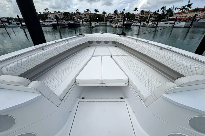 Our Trade Yacht Photos Pics Luxurious seating area on 2024 HCB 53 Sueños boat, docked in a marina.