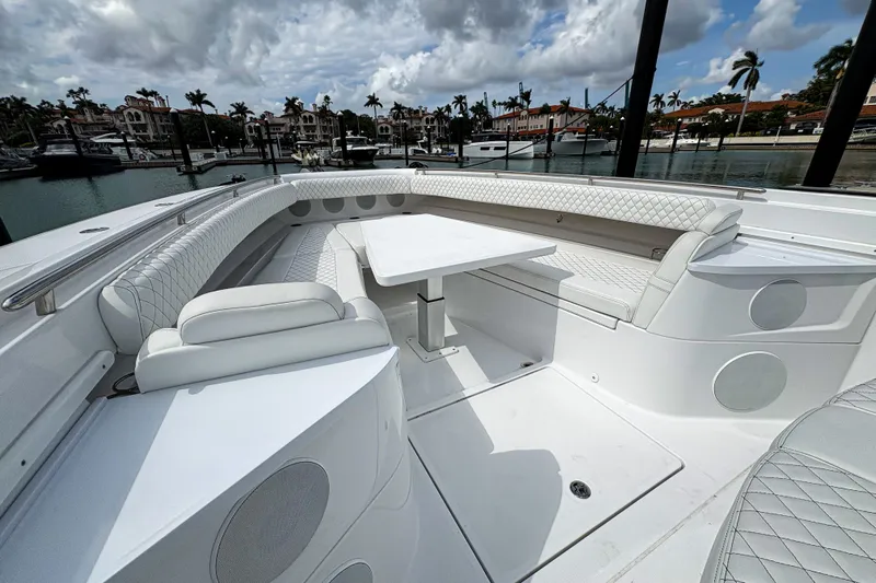 Our Trade Yacht Photos Pics 2024 HCB 53 Sueños luxury boat interior with white seating and table, docked at marina.