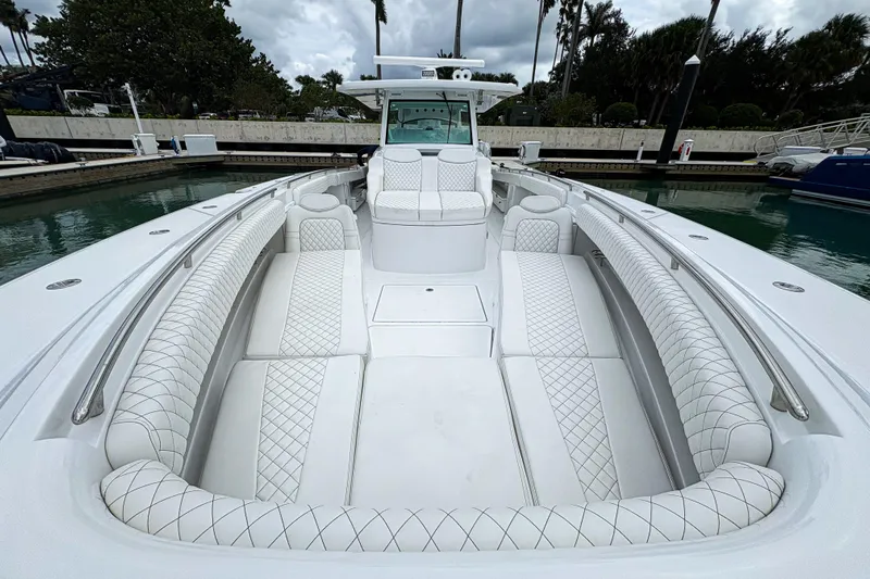 Our Trade Yacht Photos Pics 2024 HCB 53 Sueños luxury boat with elegant white seating at a marina.