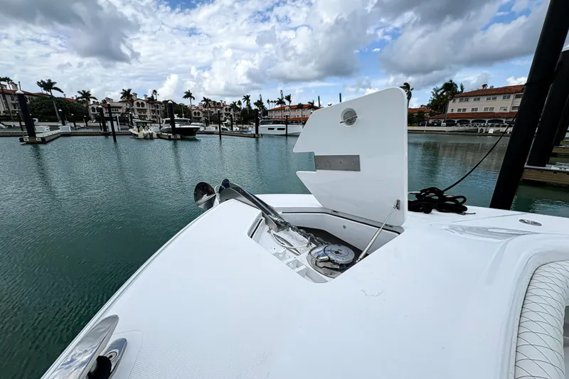 Our Trade Yacht Photos Pics 2024 HCB 53 Sueños yacht at marina, open anchor compartment, cloudy sky backdrop.