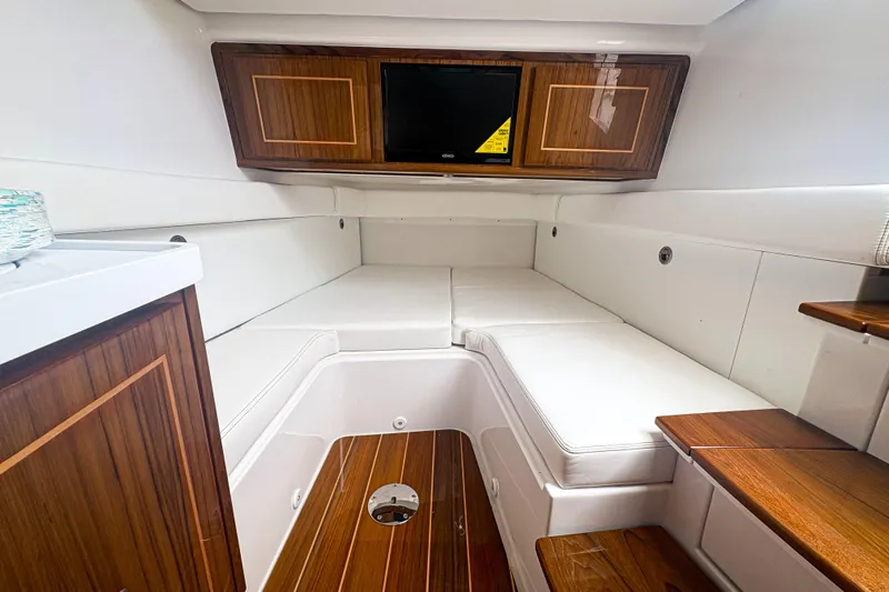 Our Trade Yacht Photos Pics 2024 HCB 53 Sueños cabin interior with white seating and wooden accents.