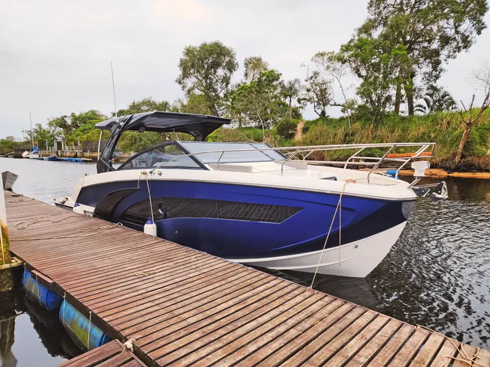 Custom Order Your 347 Today! Yacht Photos Pics 2025 Hanover 347 Inboard boat docked on a serene river with lush greenery.