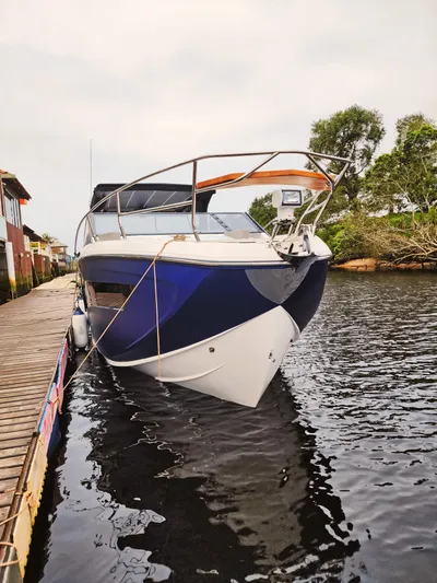 Custom Order Your 347 Today! Yacht Photos Pics 2025 Hanover 347 Inboard boat docked on calm water, surrounded by trees.