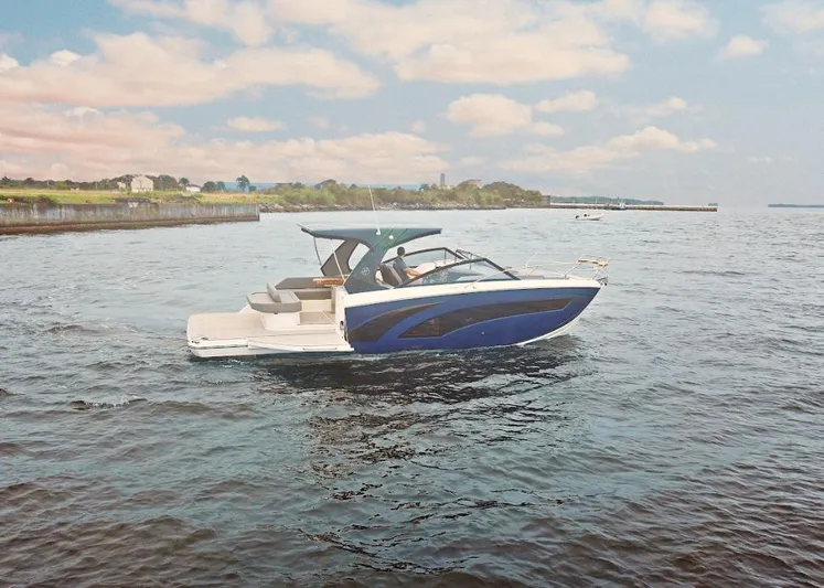 Custom Order Your 347 Today! Yacht Photos Pics 2025 Hanover 347 Inboard boat cruising on a calm lake under a partly cloudy sky.