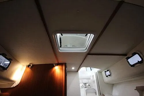  Yacht Photos Pics Manufacturer Provided Image: Interior view of 2025 NorthCoast 285 HT boat, featuring ceiling hatch and modern lighting.