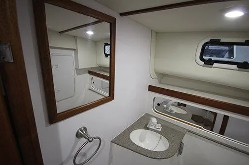  Yacht Photos Pics Manufacturer Provided Image: 2025 NorthCoast 285 HT boat interior bathroom with sink, mirror, and window.