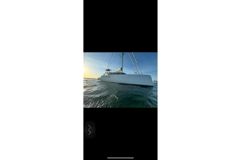 Who Cares Yacht Photos Pics Sailing yacht NEEL 51, 2020 model, on calm ocean waters at sunset.