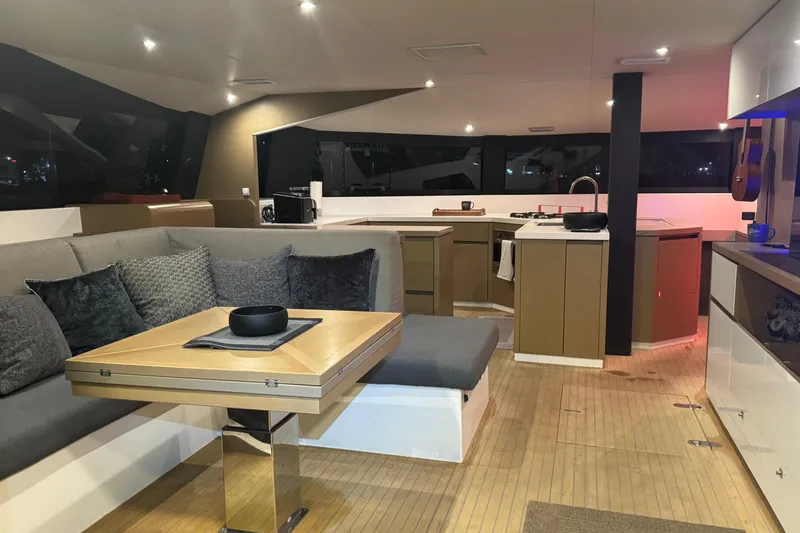 Who Cares Yacht Photos Pics Luxurious interior of 2020 NEEL 51 yacht with modern kitchen and cozy seating area.