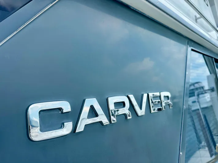 Dawn Yacht Photos Pics Close-up of 1995 Carver 440 Aft Cabin Motor Yacht logo on hull.