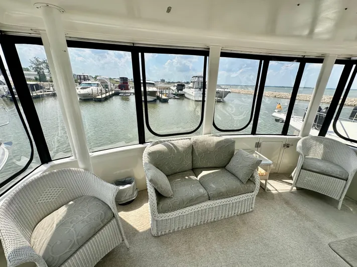 Dawn Yacht Photos Pics Interior of 1995 Carver 440 Aft Cabin Motor Yacht with wicker furniture and marina view.