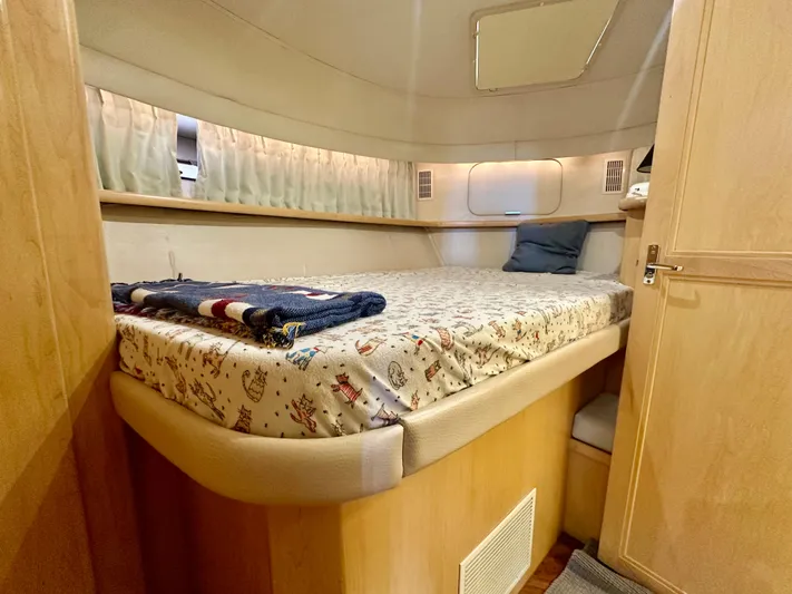 Dawn Yacht Photos Pics Cozy bedroom in 1995 Carver 440 Aft Cabin Motor Yacht with nautical-themed bedding.