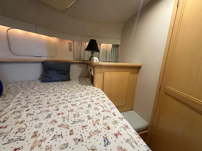 Dawn Yacht Photos Pics Cozy cabin interior of 1995 Carver 440 Aft Cabin Motor Yacht with patterned bedding.