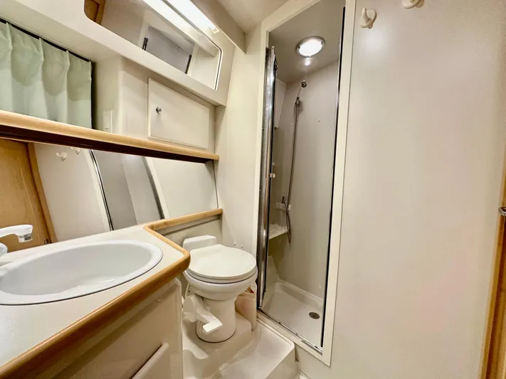 Dawn Yacht Photos Pics 1995 Carver 440 Aft Cabin Motor Yacht bathroom with shower, sink, and toilet.
