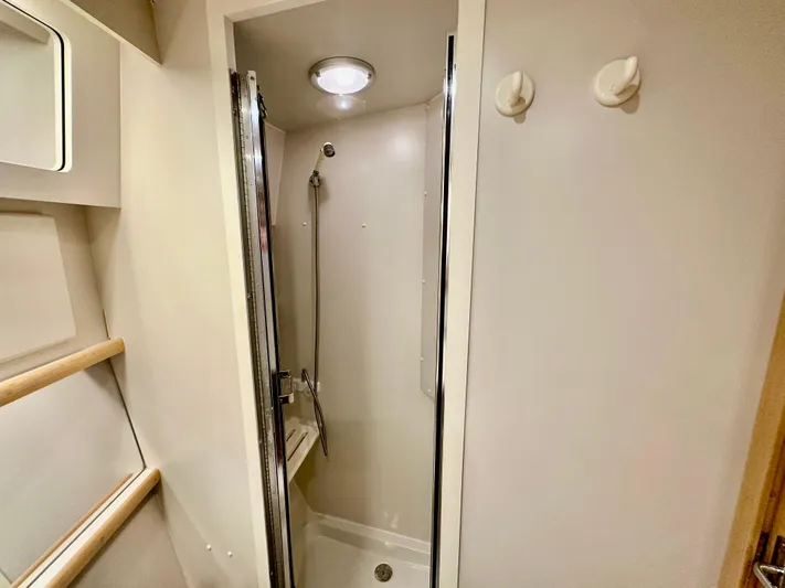 Dawn Yacht Photos Pics Shower area in 1995 Carver 440 Aft Cabin Motor Yacht, featuring modern fixtures and lighting.