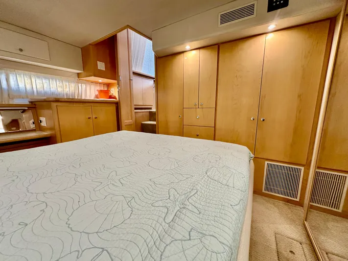 Dawn Yacht Photos Pics Interior of 1995 Carver 440 Aft Cabin Motor Yacht, featuring cozy bedroom with wood cabinetry.