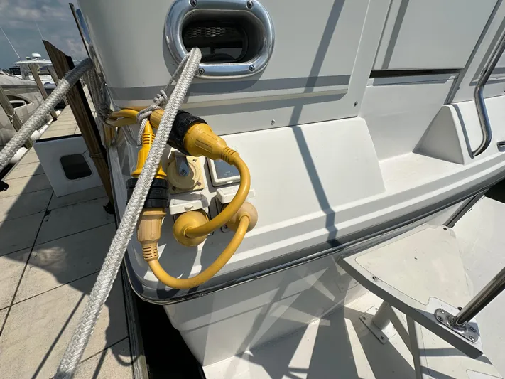 Dawn Yacht Photos Pics Power cables connected to a 1995 Carver 440 Aft Cabin Motor Yacht at a dock.