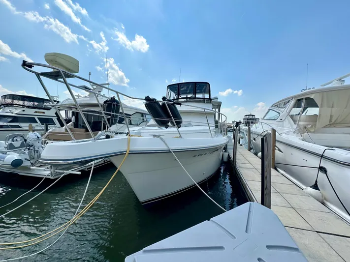 Dawn Yacht Photos Pics 1995 Carver 440 Aft Cabin Motor Yacht docked at marina under blue sky.
