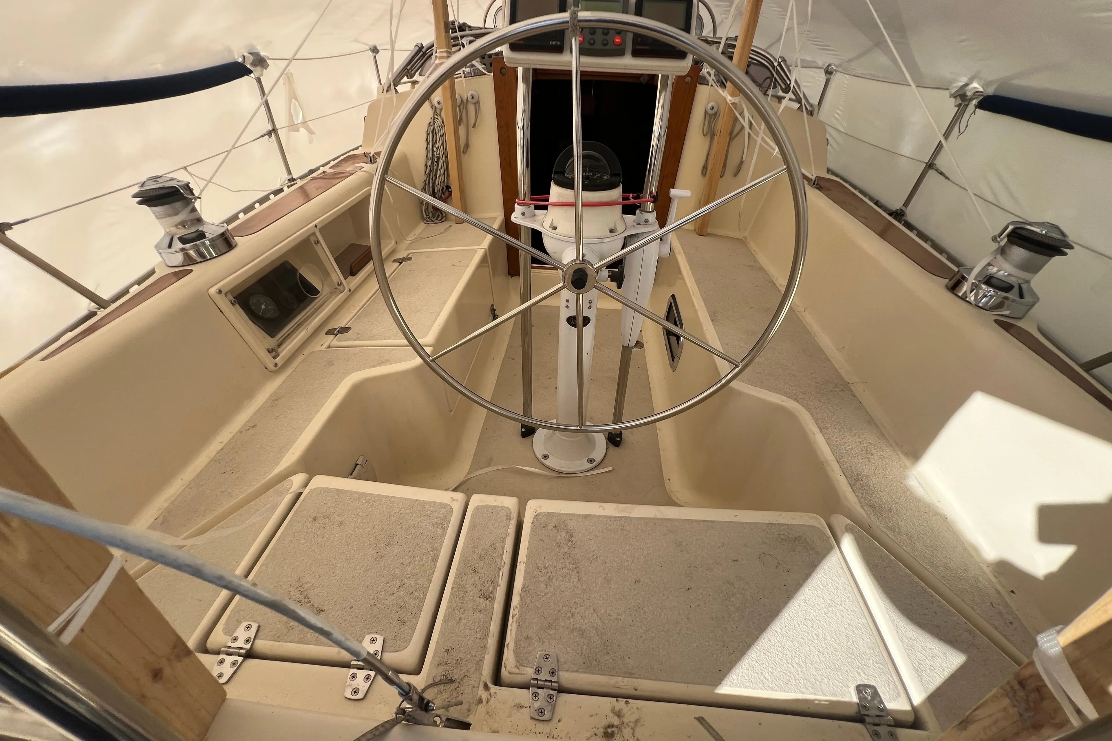1996 Caliber 35 LRC sailboat cockpit with steering wheel and navigation equipment.