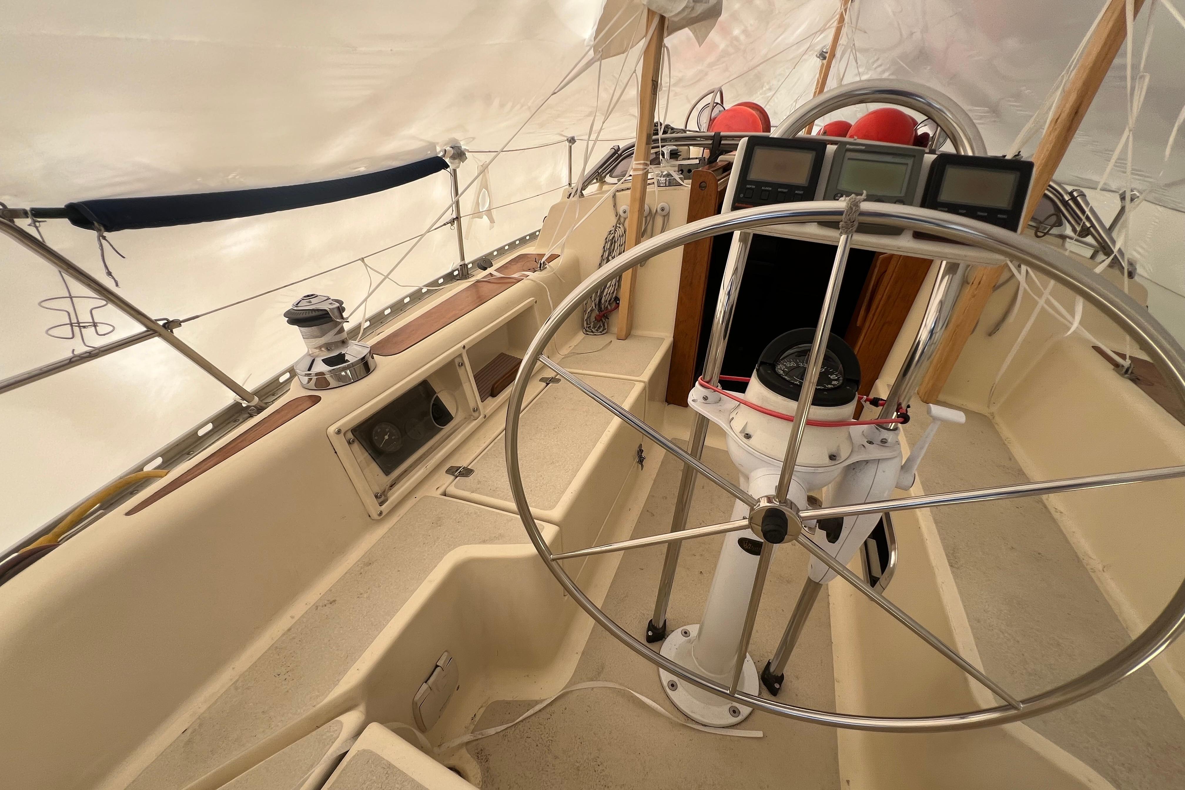 1996 Caliber 35 LRC sailboat cockpit with steering wheel and navigation instruments.