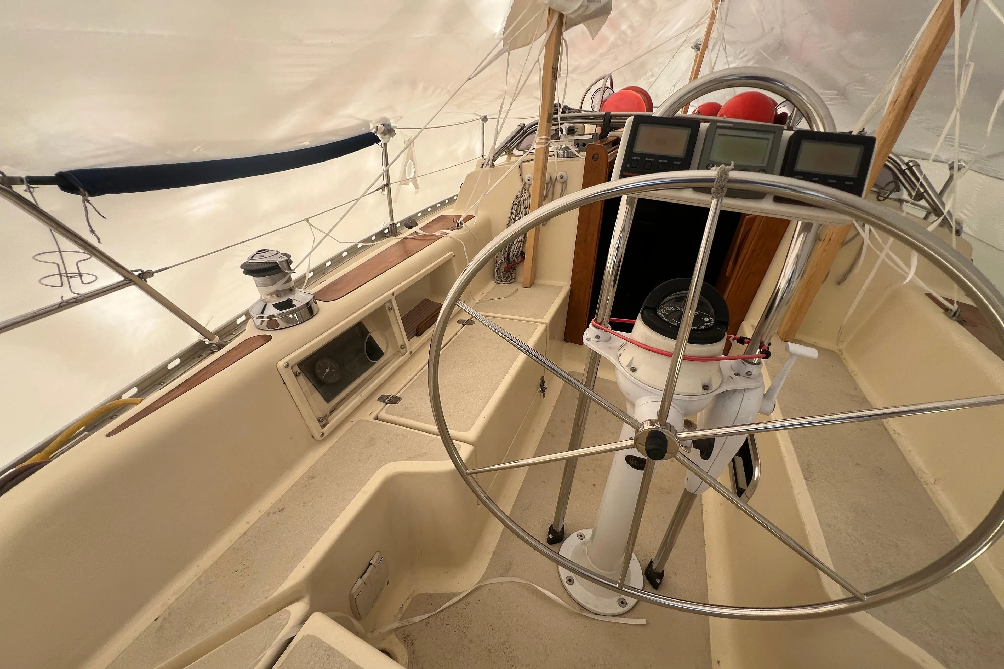 1996 Caliber 35 LRC sailboat cockpit with steering wheel and navigation instruments.