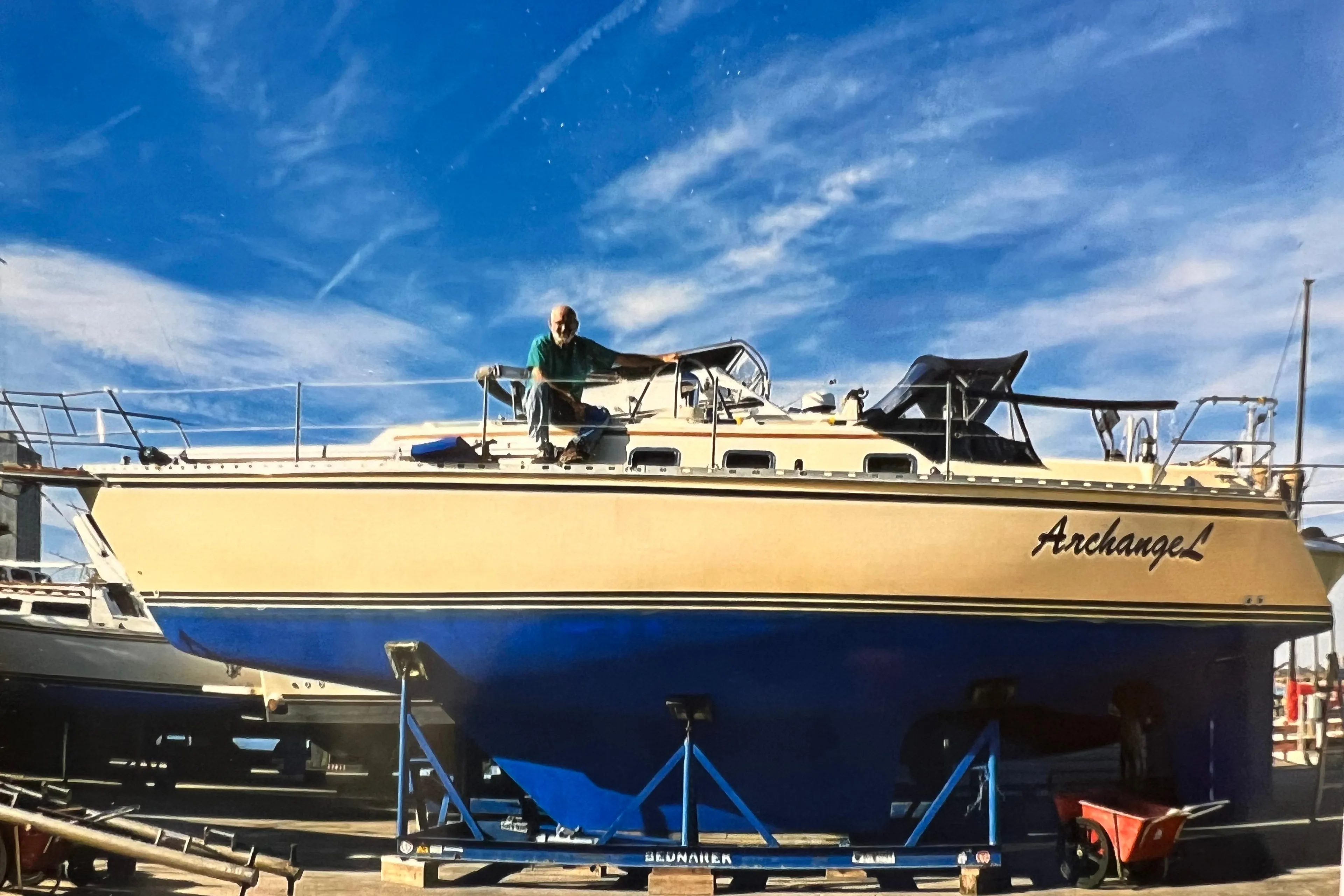 1996 Caliber 35 LRC sailboat "Archangel" on a trailer under a clear blue sky.