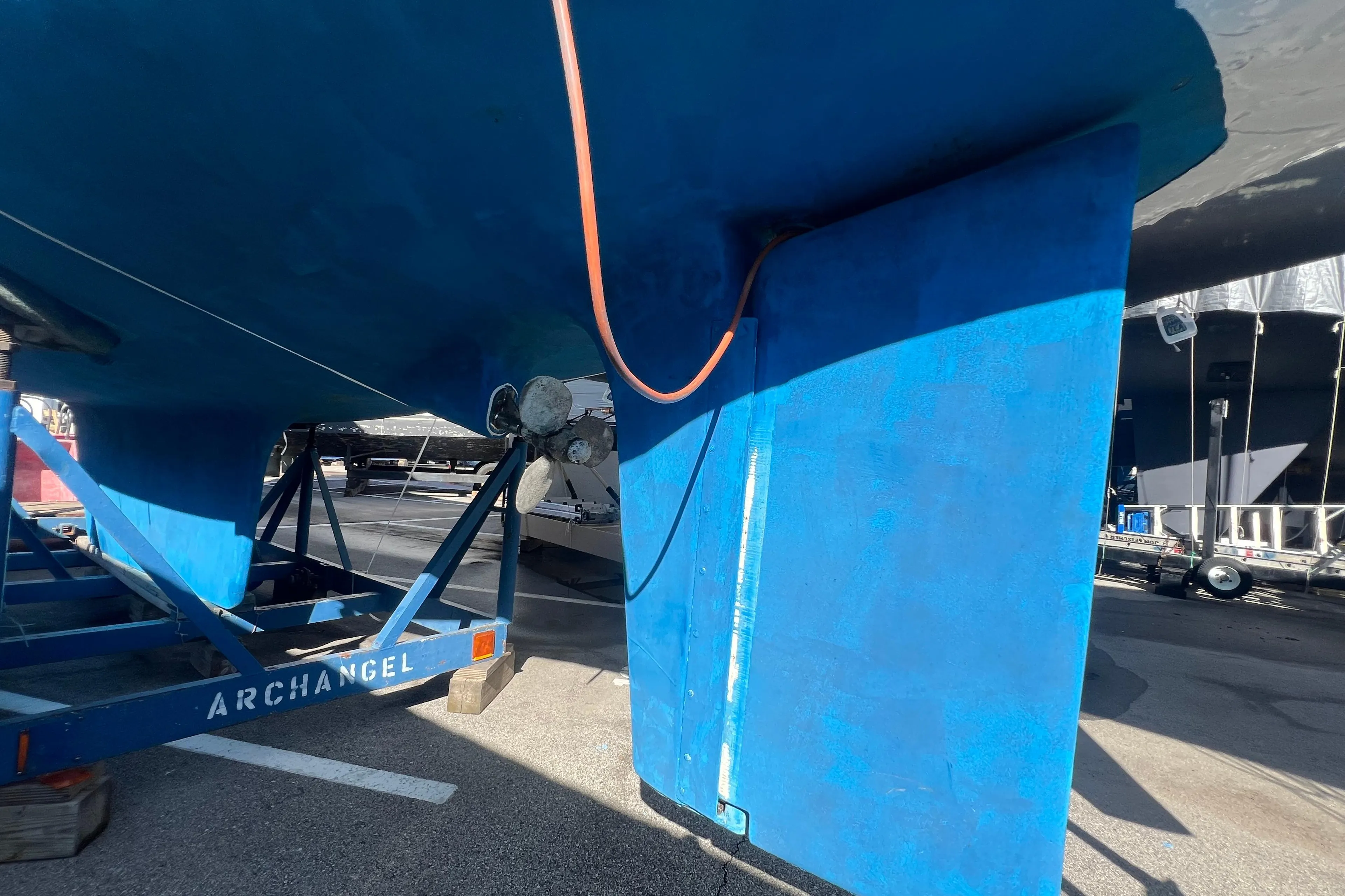 1996 Caliber 35 LRC sailboat on trailer, blue hull, rudder visible.