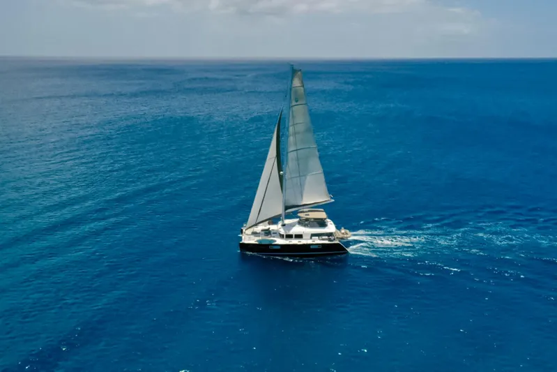 Cool Runnings IV Yacht Photos Pics Sailing yacht Lagoon 560 S2, 2015 model, cruising on open blue sea.