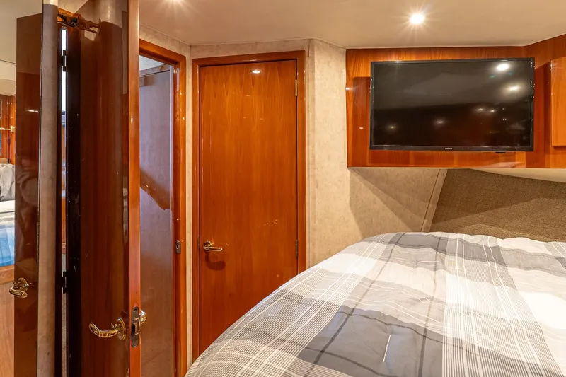 Peeling Drag Yacht Photos Pics Interior of 2003 Egg Harbor 42 Convertible yacht with wood paneling and mounted TV.
