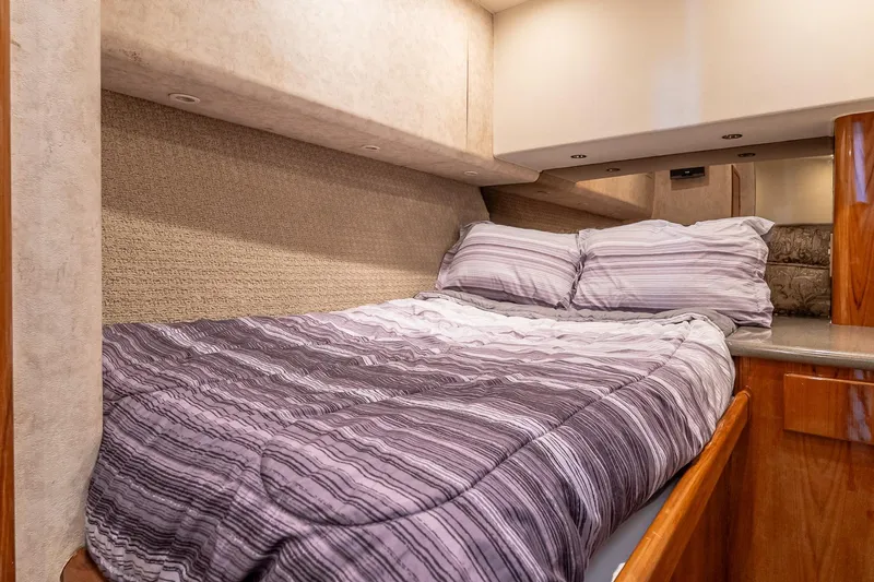 Peeling Drag Yacht Photos Pics Cozy bedroom interior of 2003 Egg Harbor 42 Convertible yacht with striped bedding.