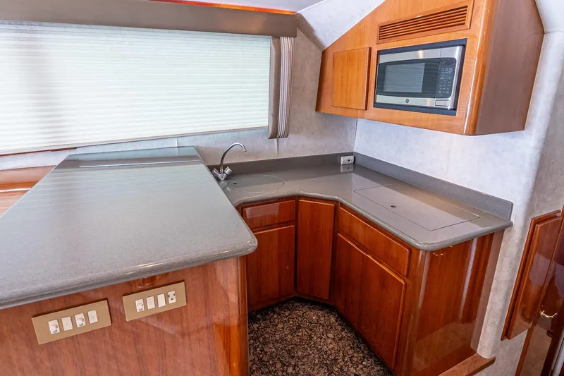 Peeling Drag Yacht Photos Pics 2003 Egg Harbor 42 Convertible yacht kitchen with modern appliances and sleek wooden cabinetry.