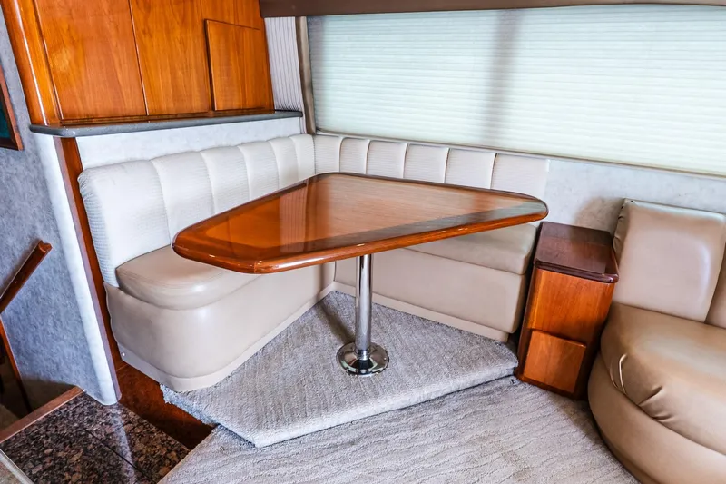 Peeling Drag Yacht Photos Pics Luxurious interior of 2003 Egg Harbor 42 Convertible yacht with elegant dining area.