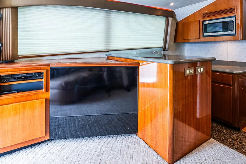 Peeling Drag Yacht Photos Pics Interior of 2003 Egg Harbor 42 Convertible yacht with wood cabinetry and modern appliances.