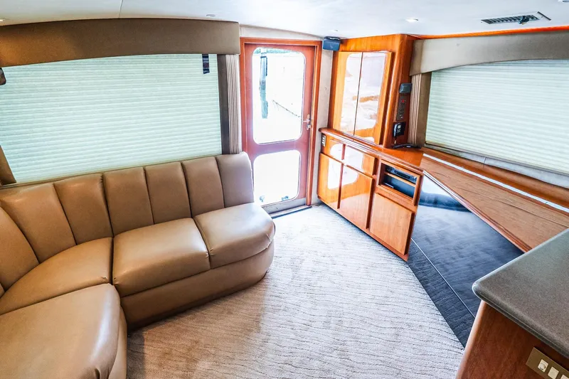 Peeling Drag Yacht Photos Pics Luxurious interior of 2003 Egg Harbor 42 Convertible yacht with plush seating and elegant wood finishes.