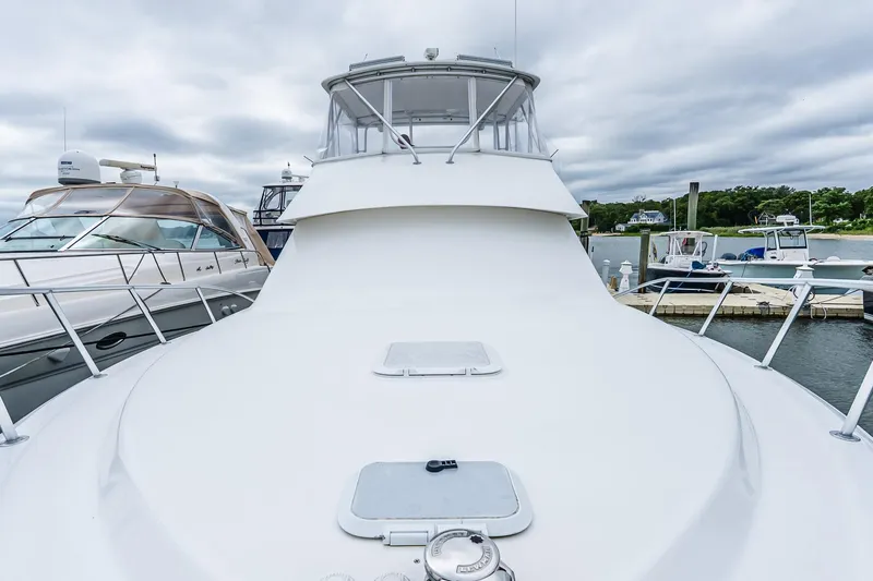 Peeling Drag Yacht Photos Pics 2003 Egg Harbor 42 Convertible yacht docked at marina under cloudy sky.