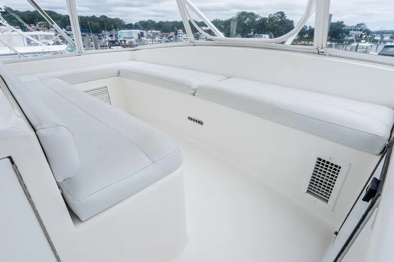 Peeling Drag Yacht Photos Pics 2003 Egg Harbor 42 Convertible yacht interior with white seating and marina view.