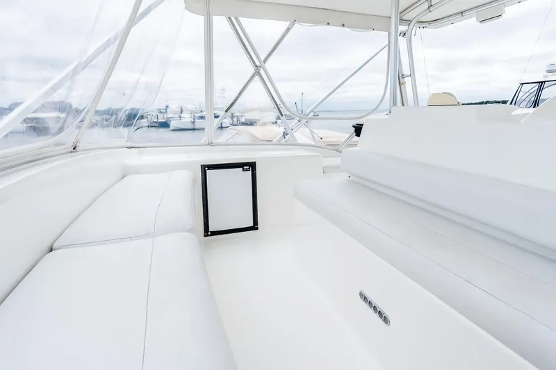 Peeling Drag Yacht Photos Pics 2003 Egg Harbor 42 Convertible yacht interior with white seating and clear windows.