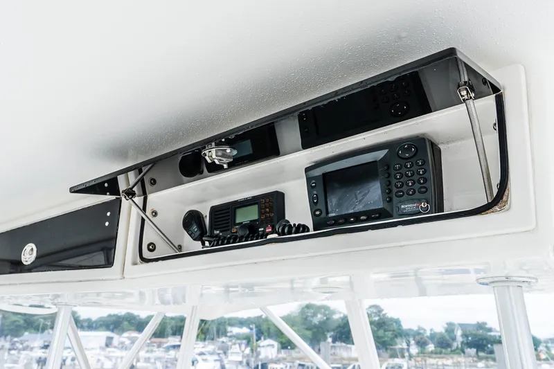 Peeling Drag Yacht Photos Pics 2003 Egg Harbor 42 Convertible boat electronics panel with navigation and communication devices.