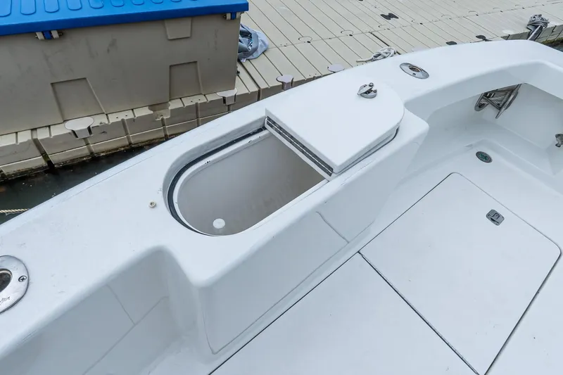 Peeling Drag Yacht Photos Pics 2003 Egg Harbor 42 Convertible boat deck with storage compartment at dock.