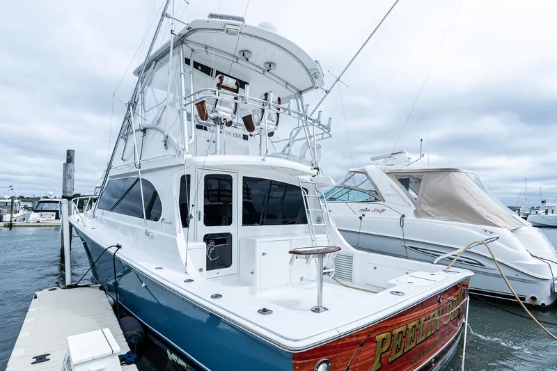 Peeling Drag Yacht Photos Pics 2003 Egg Harbor 42 Convertible yacht docked at marina under cloudy sky.