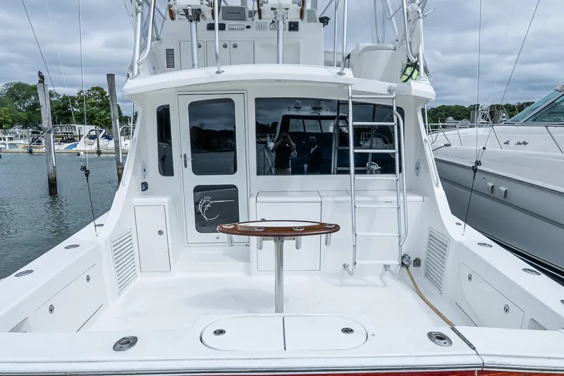 Peeling Drag Yacht Photos Pics 2003 Egg Harbor 42 Convertible yacht, spacious deck, docked at marina.