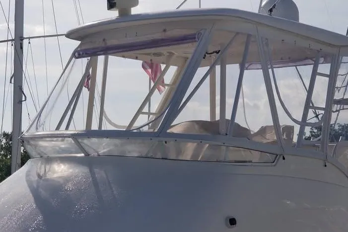 Plane Pirate Yacht Photos Pics 2004 Riviera 37 Convertible yacht with clear windows and sleek design.