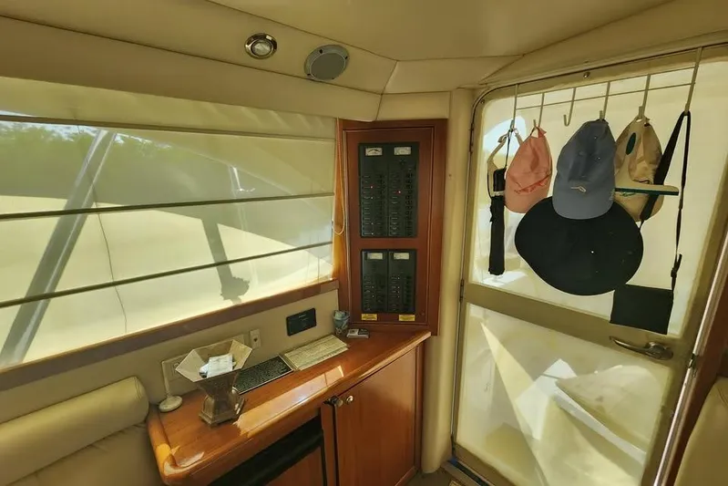 Plane Pirate Yacht Photos Pics Interior of 2004 Riviera 37 Convertible yacht with control panel and hanging hats.