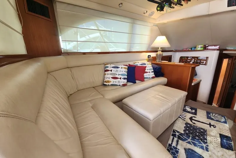 Plane Pirate Yacht Photos Pics Luxurious interior of 2004 Riviera 37 Convertible yacht with beige leather seating and nautical decor.