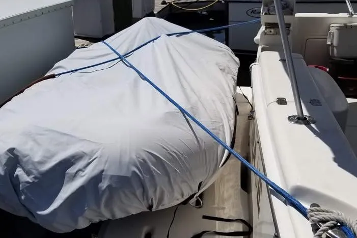 Plane Pirate Yacht Photos Pics Covered boat on a 2004 Riviera 37 Convertible, secured with blue rope.