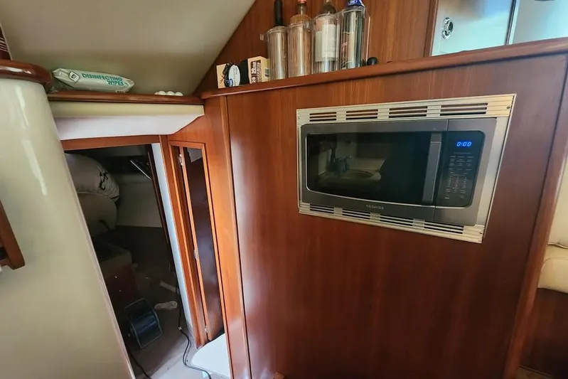 Plane Pirate Yacht Photos Pics Interior of 2004 Riviera 37 Convertible with microwave and wooden cabinetry.
