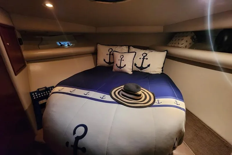 Plane Pirate Yacht Photos Pics Cozy cabin interior of 2004 Riviera 37 Convertible with nautical-themed bedding and decor.